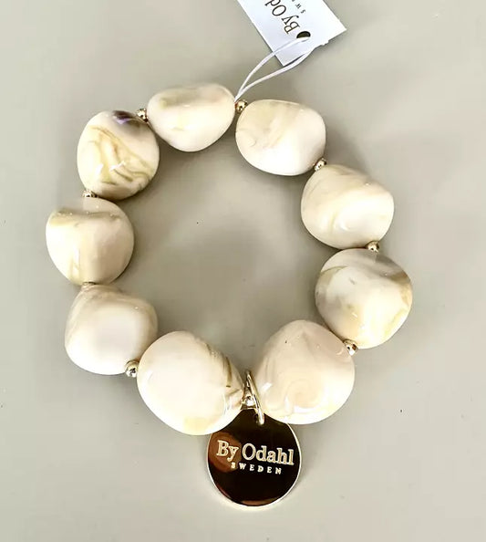 Cremevitt armband marmorerade pärlor